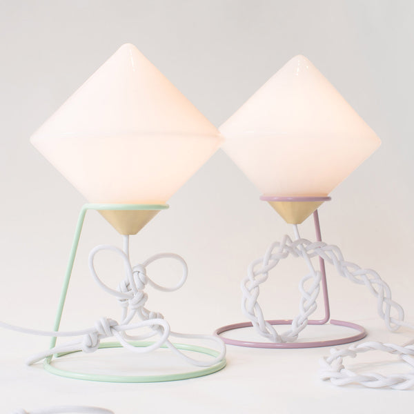 New York designer Bec Brittain has created lights with candy-coloured stands, ivory glass shades and decorative strips of suede for her latest collection