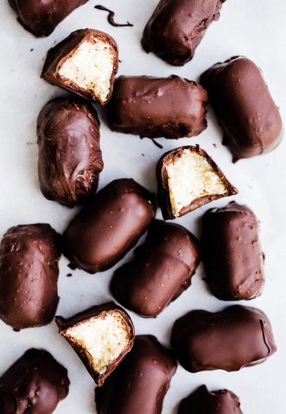 This Vegan Chocolate Covered Coconut Candy recipe uses shredded unsweetened coconut, maple syrup, and dairy-free chocolate chips